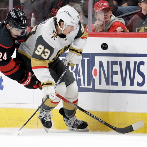FILE - Carolina Hurricanes center Seth Jarvis (24) and Vegas Golden Knights right wing Mitch Marner (93) go for the puck during the first period of an NHL hockey game, Oct. 28, 2025, in Raleigh, N.C. (AP Photo/Chris Seward, file)