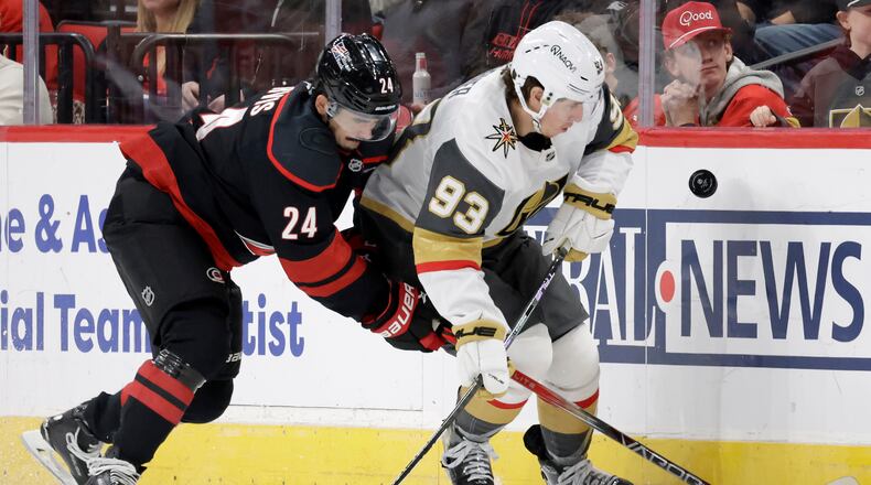 FILE - Carolina Hurricanes center Seth Jarvis (24) and Vegas Golden Knights right wing Mitch Marner (93) go for the puck during the first period of an NHL hockey game, Oct. 28, 2025, in Raleigh, N.C. (AP Photo/Chris Seward, file)