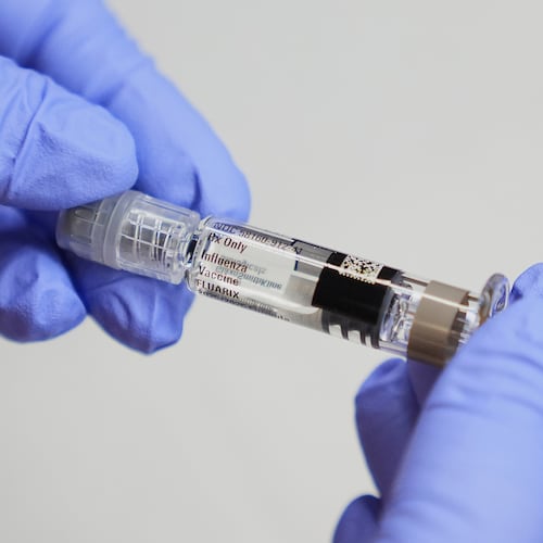 FILE - A certified medical assistant holds a syringe for a flu vaccine at a clinic in Seattle, on Sept. 10, 2025. (AP Photo/Lindsey Wasson, File)