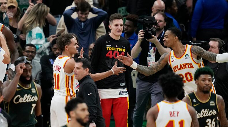 Atlanta Hawks guard Trae Young (11) is congratulated after the team's win over the Boston Celtics in Game 5 in a first-round NBA basketball playoff series Tuesday, April 25, 2023, in Boston. (AP Photo/Charles Krupa)