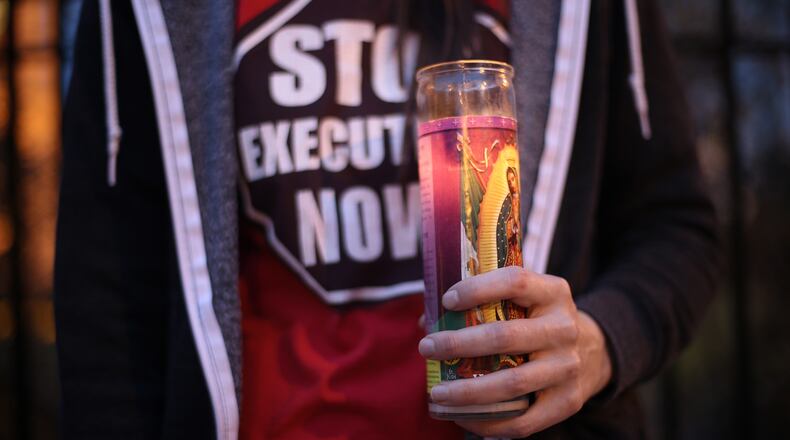 In March 2015, a death-penalty opponent held a candle during a vigil in Atlanta for Kelly Gissendaner, the only woman on Georgia’s death row, who was ultimately executed on September 30th of that year. Now another inmate, Steven Spears, is slated to become the eighth person executed in Georgia in 2016. But his former wife is fighting to overturn his death sentence — because Spears has steadfastly refused to do so. (credit: BEN GRAY / bgray@ajc.com/ 2015 file photo)