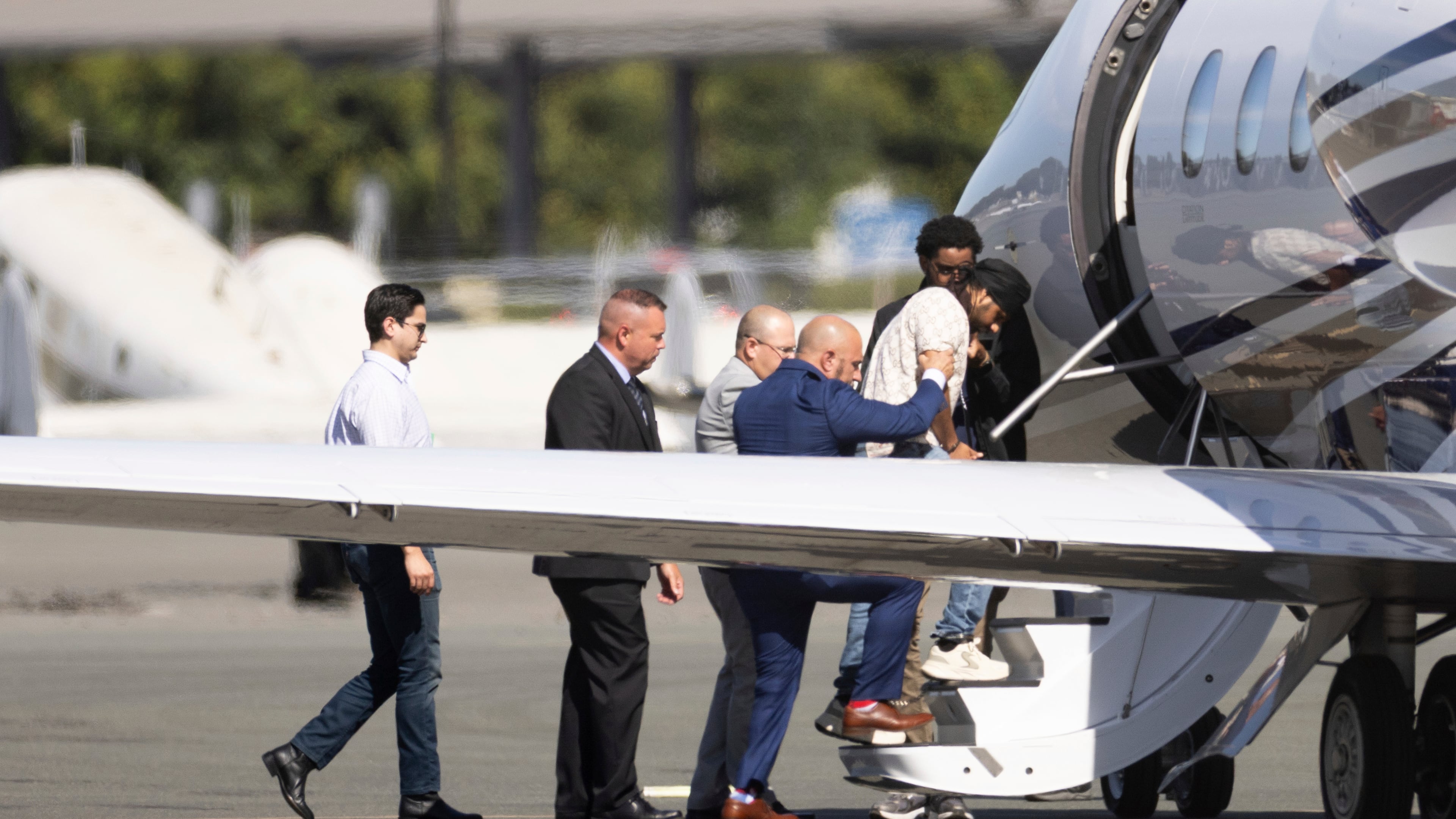 FILE - Harjinder Singh is escorted onto an airplane by Florida Lt. Gov. Jay Collins and law enforcement on Thursday, Aug. 21, 2025, in Stockton, Calif. (AP Photo/Benjamin Fanjoy, file)