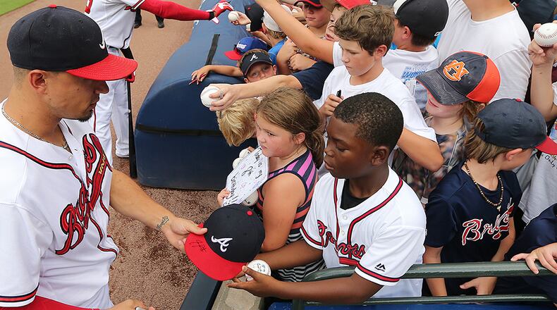 Braves infielder Jace Peterson signs autographs for young fans at Turner Field.