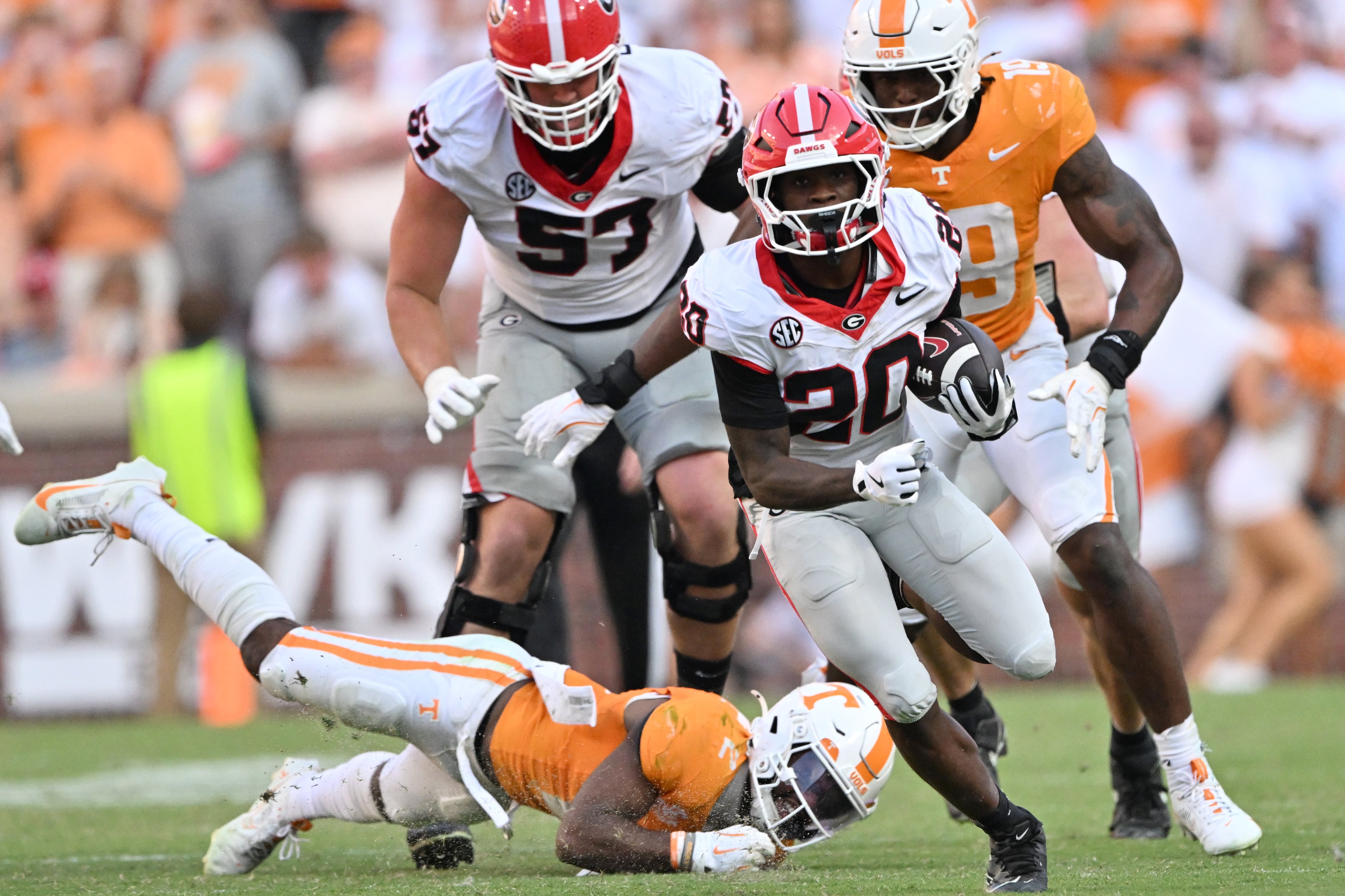 Georgia running back Dwight Phillips Jr. (right) runs for a first down during the second half against Tennessee at Neyland Stadium on Saturday, Sept. 13, 2025, in Knoxville, Tenn. Georgia won 44-41 in overtime. (Hyosub Shin/AJC)