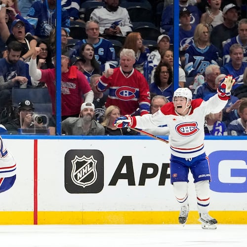 Montréal Canadiens left wing Juraj Slafkovský (20) celebrates his goal with right wing Cole Caufield against the Tampa Bay Lightning during overtime in Game 1 of an NHL hockey Stanley Cup first-round playoff series, Sunday, April 19, 2026, in Tampa, Fla. (AP Photo/Chris O'Meara)
