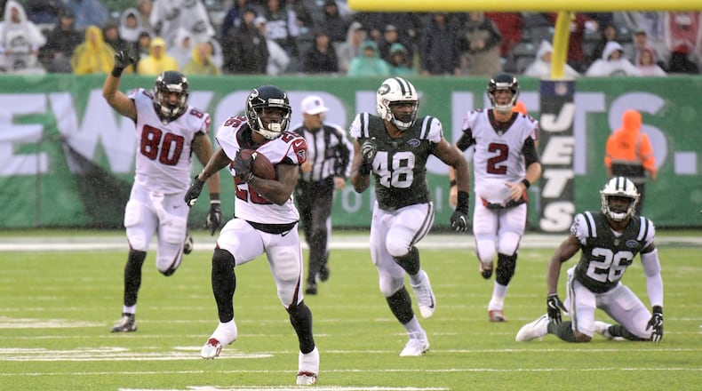 Atlanta Falcons running back Tevin Coleman (26) is pursued by New York Jets outside linebacker Jordan Jenkins (48) during the second half of an NFL football game against the New York Jets Sunday, Oct. 29, 2017, in East Rutherford, N.J. (AP Photo/Bill Kostroun)