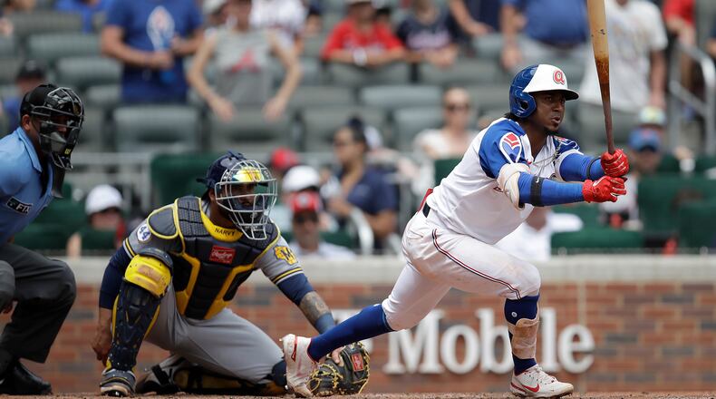 Braves' Ozzie Albies (right) grounds out in the seventh inning against the Milwaukee Brewers Sunday, Aug. 1, 2021, at Truist Park in Atlanta. (Ben Margot/AP)