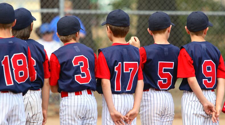 Little League players standing in line before a game.