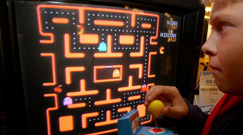 In this Oct. 5, 2004, file photo, Jake Gautney, 12, of Chappaqua, N.Y., tries a Ms. Pac-Man game at the Toy Industry Association holiday preview in New York. Masaya Nakamura, the "Father of Pac-Man" who founded the Japanese video game company behind the hit creature-gobbling game, died on Jan. 22, 2017. He was 91.