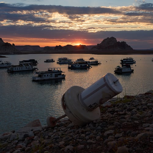 FILE - A formerly floating buoy now sits high and dry above Lake Powell at the Glen Canyon National Recreation Area, July 15, 2026, near Page, Nev. (AP Photo/John Locher, File)