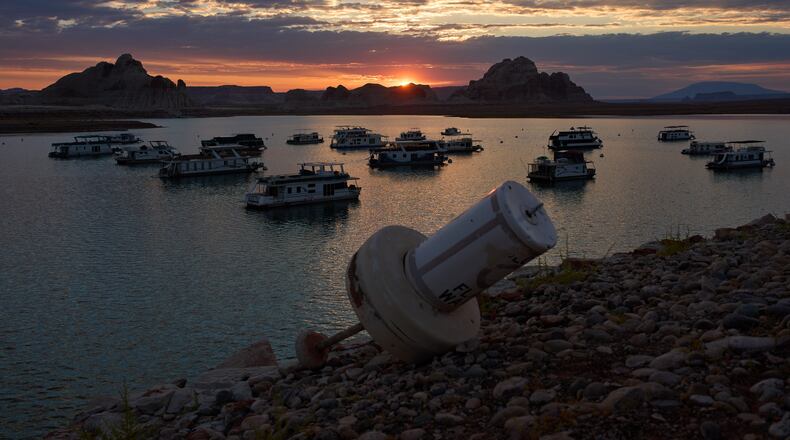 FILE - A formerly floating buoy now sits high and dry above Lake Powell at the Glen Canyon National Recreation Area, July 15, 2026, near Page, Nev. (AP Photo/John Locher, File)