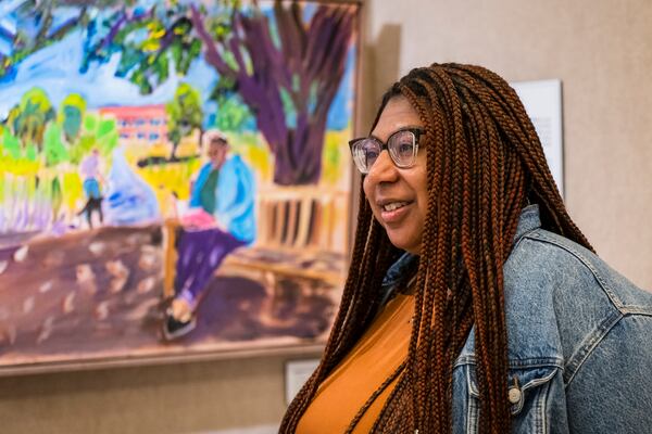 Devon Yarbrough, Digital Communications Manager at the George W. Bush Presidential Center, speaks about being part of one of the paintings by President George W. Bush on display in an exhibit at the George W. Bush Presidential Museum, Thursday, May 15, 2025, in Dallas. (AP Photo/Jessica Tobias)