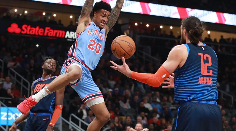 Atlanta Hawks forward John Collins slams for two with Oklahoma City Thunder center Steven Adams looking on during the first half in a NBA basketball game on Tuesday, Jan. 15, 2019, at State Farm Arena in Atlanta.    Curtis Compton/ccompton@ajc.com