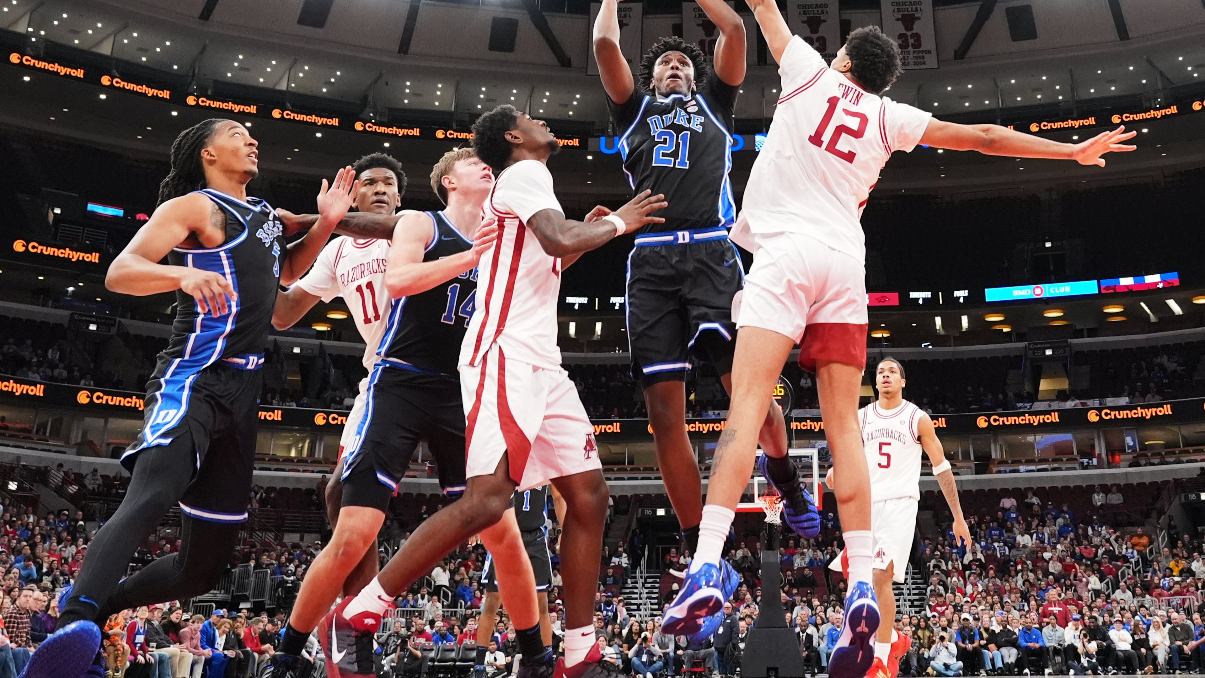 Duke center Patrick Ngongba (21) shoots against Arkansas forward Malique Ewin (12) during the first half of an NCAA college basketball game in the CBS Sports Thanksgiving Classic tournament Thursday, Nov. 27, 2025, in Chicago. (AP Photo/Nam Y. Huh)