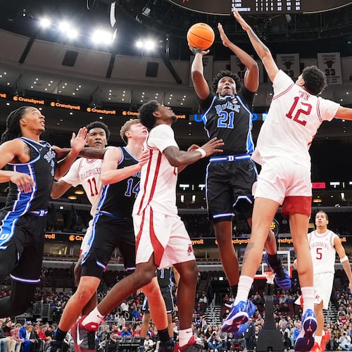Duke center Patrick Ngongba (21) shoots against Arkansas forward Malique Ewin (12) during the first half of an NCAA college basketball game in the CBS Sports Thanksgiving Classic tournament Thursday, Nov. 27, 2025, in Chicago. (AP Photo/Nam Y. Huh)