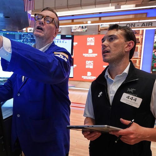 Specialist Patrick King, left, and trader Dylan Halvorsen work on the floor of the New York Stock Exchange, Thursday, June 25, 2026. (AP Photo/Richard Drew)