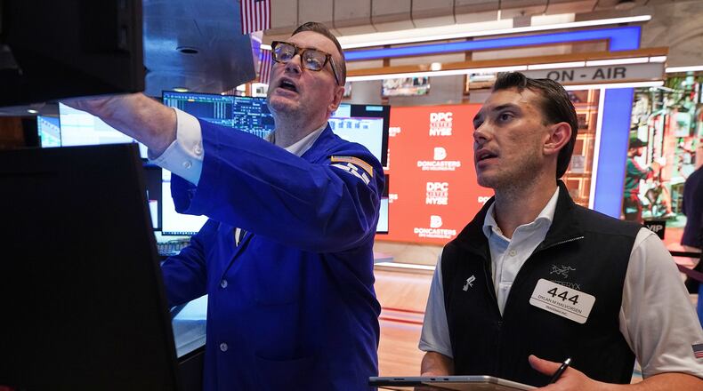 Specialist Patrick King, left, and trader Dylan Halvorsen work on the floor of the New York Stock Exchange, Thursday, June 25, 2026. (AP Photo/Richard Drew)