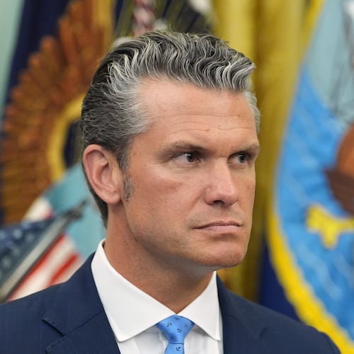 Defense Secretary Pete Hegseth listens as President Donald Trump speaks during a meeting about military families, in the Oval Office of the White House, Monday, Aug. 3, 2026, in Washington. (AP Photo/Alex Brandon)