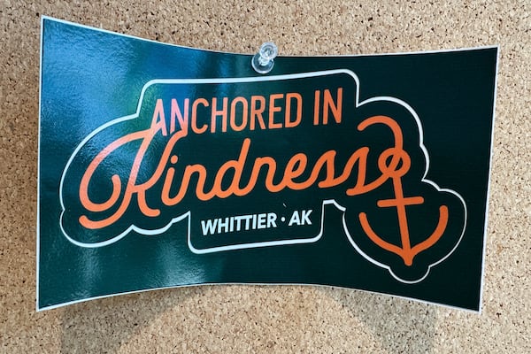 A poster with the slogan "Anchored in Kindness, Whittier, AK" is displayed in the city building in Whittier, Alaska, May 13, 2025. (AP Photo/Mark Thiessen)