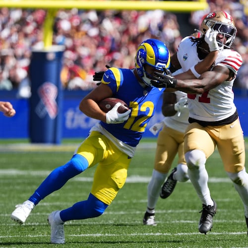Los Angeles Rams wide receiver Puka Nacua runs pass San Francisco 49ers safety Ji'ayir Brown during the first half of an NFL football game, Friday, Sept. 11, 2026, in Melbourne, Australia. (AP Photo/Scott Barbour)