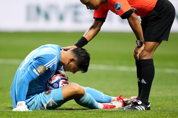 An official checks on Inter Miami's Oscar Ustari, left, during the Club World Cup round of 16 soccer match between PSG and Inter Miami in Atlanta, Sunday, June 29, 2025. (AP Photo/Brynn Anderson)
