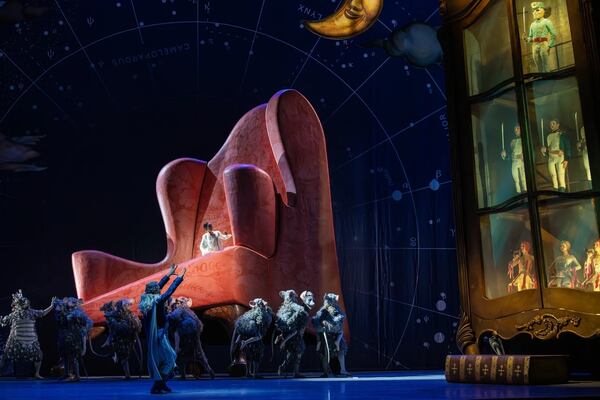 The older, dreaming Marie (Igarashi) looks on as the mice surround her larger-than-life chair.