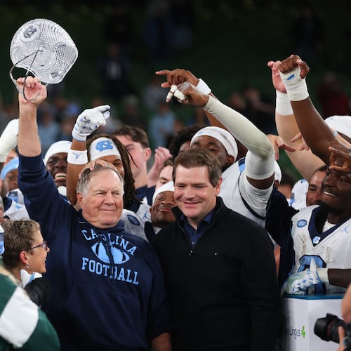North Carolina head coach Bill Belichick, center, and his team celebrate after defeating TCU in an NCAA college football game in Dublin, Ireland, Saturday, Aug. 29, 2026. (AP Photo/Peter Morrison)