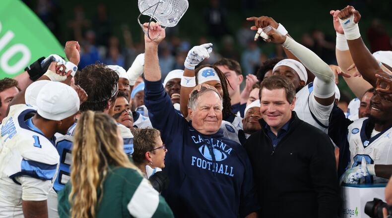 North Carolina head coach Bill Belichick, center, and his team celebrate after defeating TCU in an NCAA college football game in Dublin, Ireland, Saturday, Aug. 29, 2026. (AP Photo/Peter Morrison)