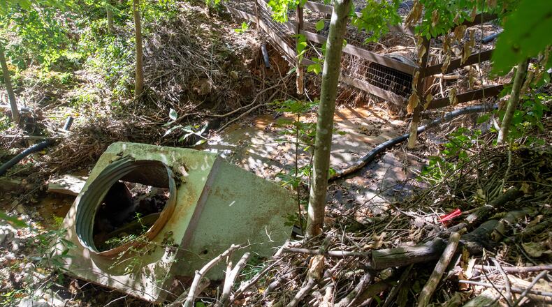 Properties in Marietta experienced significant damage after a recent flash flood that washed away storm drains under driveways and created sinkholes, knocked concrete barriers off drain pipes. (Jenni Girtman for The Atlanta Journal-Constitution)