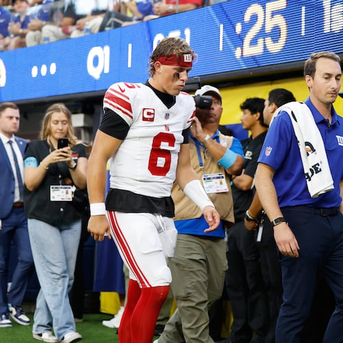 New York Giants quarterback Jaxson Dart (6) walks off the field with an injury during the first half of an NFL football game against the Los Angeles Rams in Inglewood, Calif., Monday, Sept. 21, 2026. (AP Photo/Caroline Brehman)