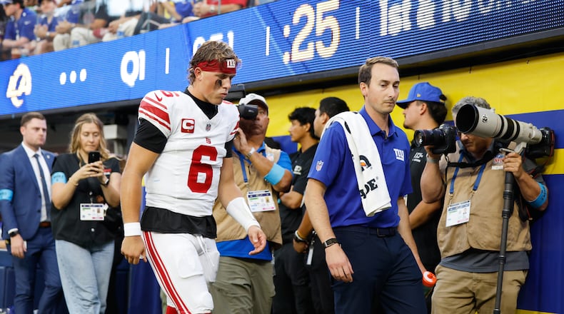 New York Giants quarterback Jaxson Dart (6) walks off the field with an injury during the first half of an NFL football game against the Los Angeles Rams in Inglewood, Calif., Monday, Sept. 21, 2026. (AP Photo/Caroline Brehman)
