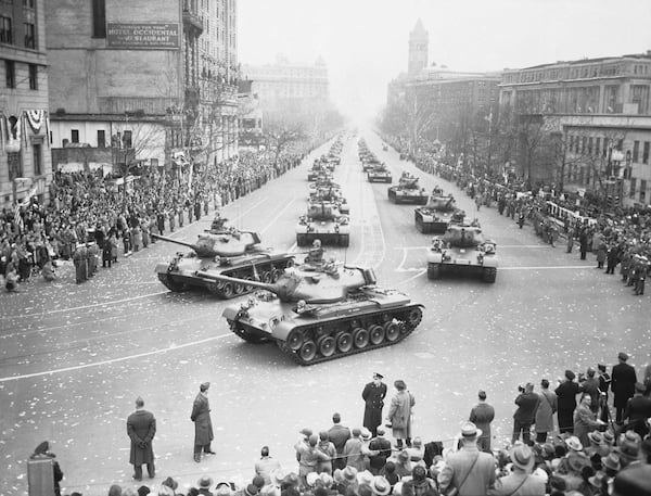 FILE - Army medium tanks move along Pennsylvania Avenue during the Inaugural Parade for President Dwight D. Eisenhower, Jan. 21, 1953, in Washington. Front tanks are turning into 15th Street on way to the reviewing stand set up in front of White House. (AP Photo, File)