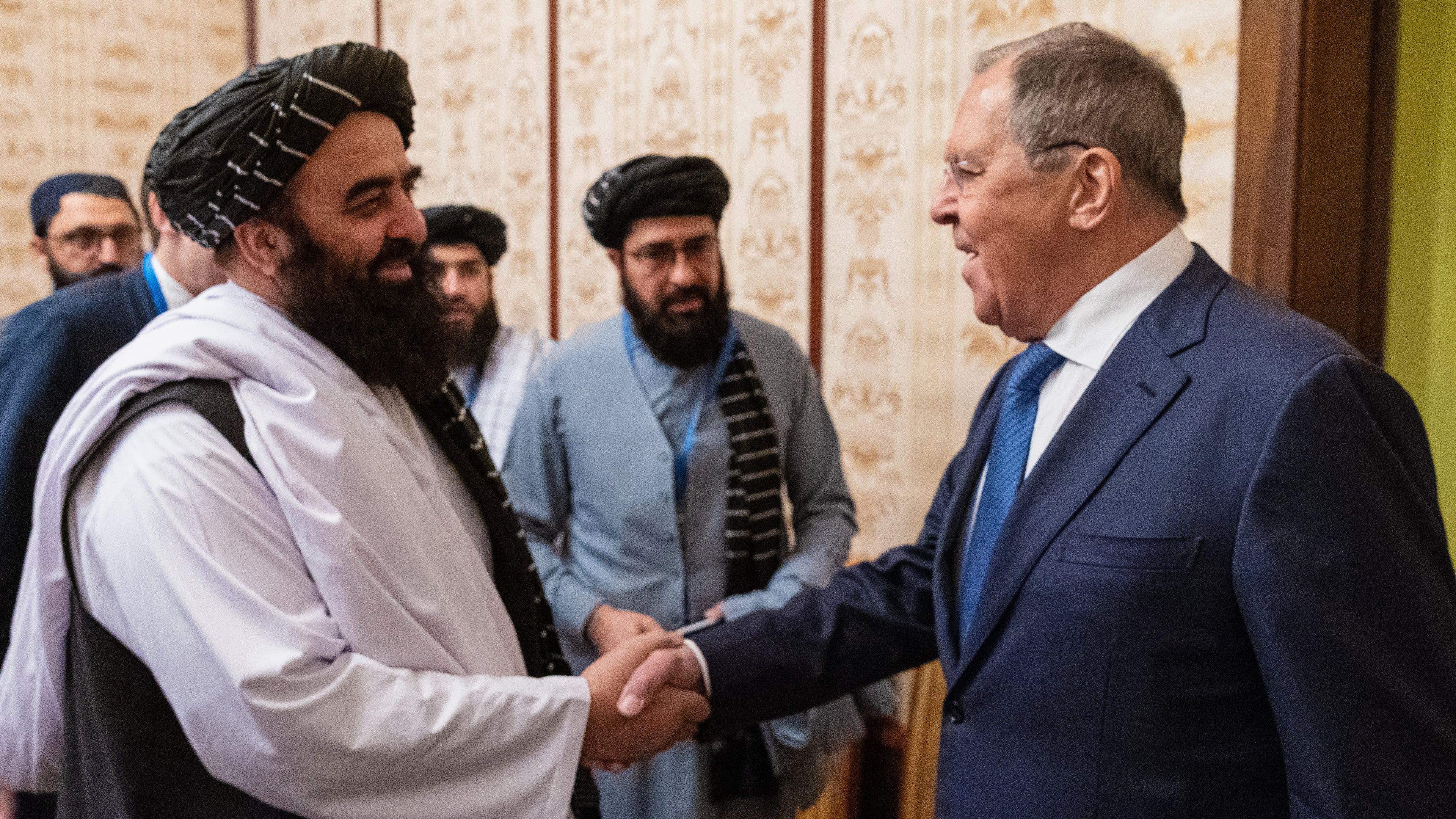 In this photo released by Russian Foreign Ministry Press Service, Afghanistan's acting Foreign Minister Amir Khan Muttaqi, front left, and Russian Foreign Minister Sergey Lavrov, right, shake hands prior to their talks on the sidelines of the Moscow format consultations on Afghanistan in Moscow, Russia, Tuesday, Oct. 7, 2025. (Russian Foreign Ministry Press Service via AP)