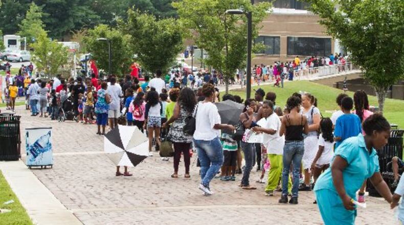 Long lines formed outside of Atlanta Metropolitan State College for Atlanta Public Schools 2015 back-to-school bash. AJC FILE PHOTO