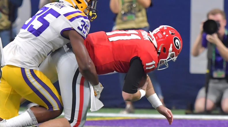 12/7/19 - Atlanta -  Georgia Bulldogs quarterback Jake Fromm (11) is sacked by LSU Tigers linebacker Damone Clark (35) during the first half of the Georgia vs. LSU SEC Football Championship game at Mercedes-Benz Stadium in Atlanta.  Hyosub Shin / hyosub.shin@ajc.com
