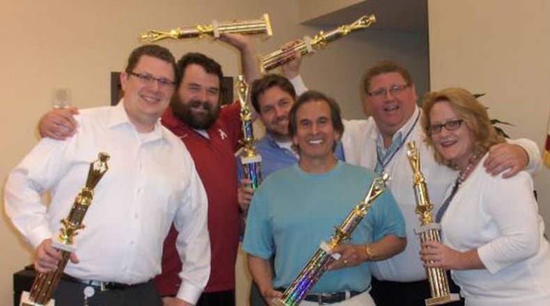 James Freaney — second from right, seen here celebrating a trivia win with fellow attorneys — died June 20. Authorities initially said he died after falling from a sidewalk in Midtown Atlanta, but his cause of death has been attributed to coronary artery disease. (Credit: Frederick J. Hanna and Associates)