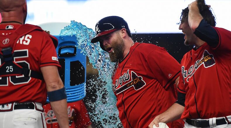 Brian McCann #16 of the Atlanta Braves celebrates with his teammates after hitting a walk off single in the bottom of the 9th to defeat the Miami Marlins at SunTrust Park on July 05, 2019 in Atlanta, Georgia. (Photo by Logan Riely/Getty Images)