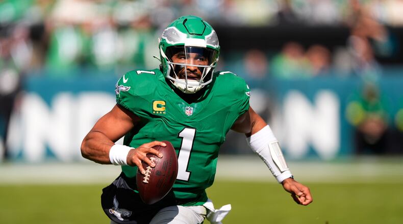 Philadelphia Eagles quarterback Jalen Hurts (1) runs with the ball during the first half of an NFL football game against the New York Giants on Sunday, Oct. 26, 2025, in Philadelphia. (AP Photo/Chris Szagola)