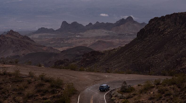 FILE - A car drives along Oatman Highway on historic Route 66, near Oatman, Ariz., on Friday, Nov. 21, 2025. (AP Photo/Jae C. Hong, File)