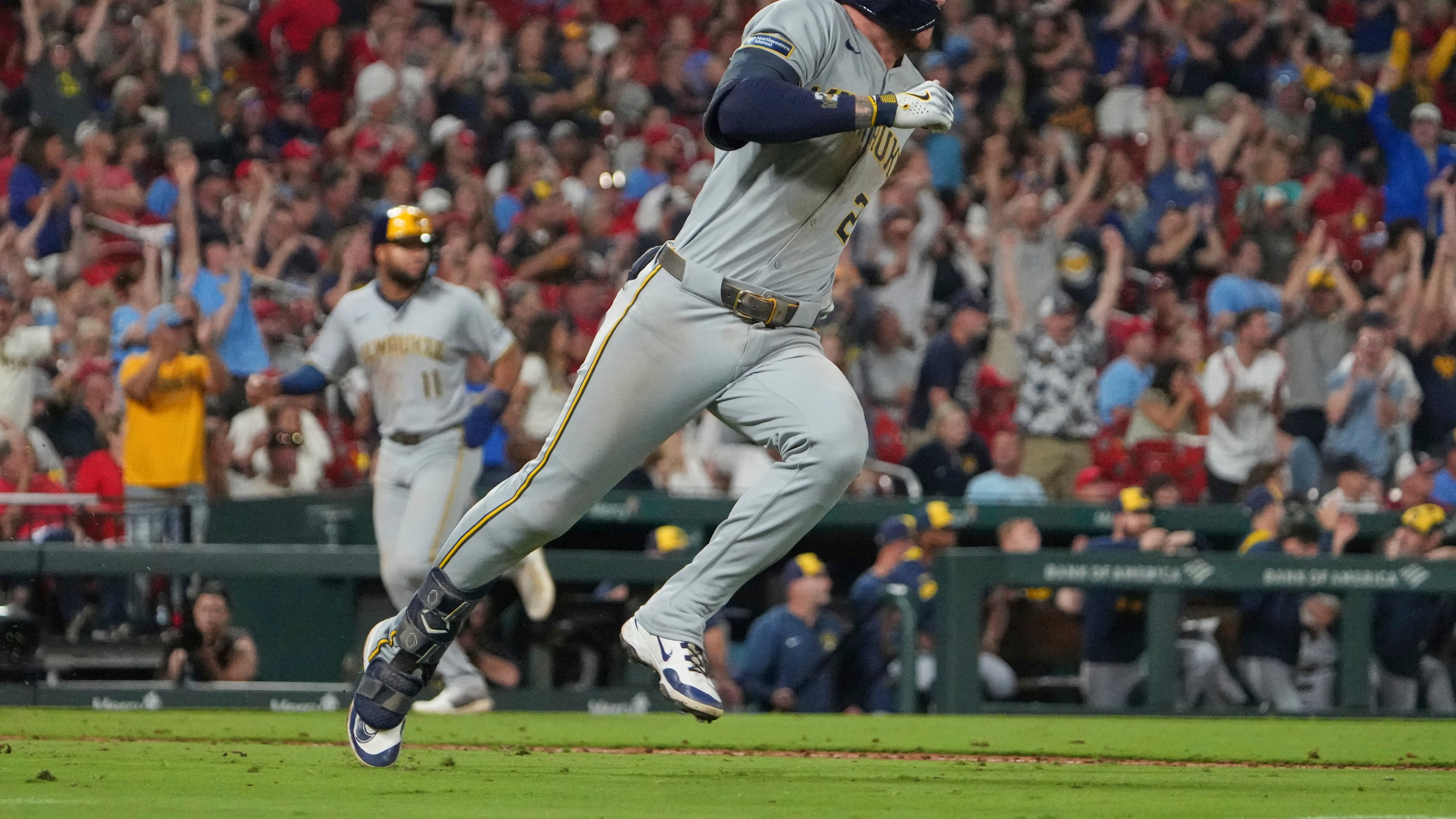 Milwaukee Brewers' Brice Turang, right, singles as Jackson Chourio, left, jogs in to score during the 10th inning of a baseball game against the St. Louis Cardinals Saturday, Sept. 20, 2025, in St. Louis. (AP Photo/Jeff Roberson)