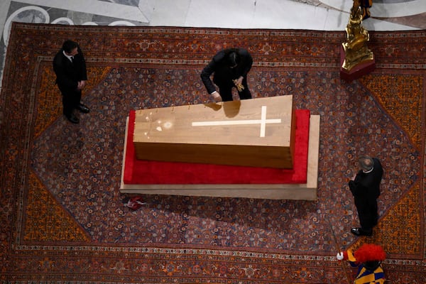 Cerimonial ushers close the casket containing the body of Pope Francis in St. Peter's Basilica at the Vatican Friday, April 25, 2025. (Vatican Media via AP)