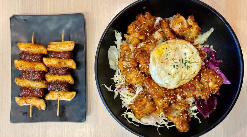 Tiger K Cupbob serves Korean street food in a fast-casual setting. Shown here are the so-tteok so-tteok (crispy rice noodles with cocktail sausages) and the Korean fried chicken cupbob.
Wendell Brock for The Atlanta Journal-Constitution