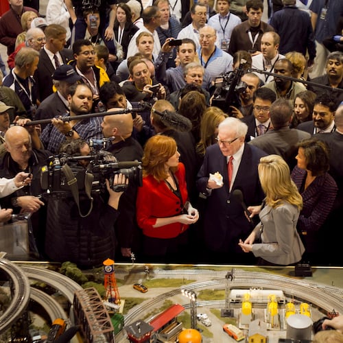 FILE - Berkshire Hathaway Chairman and CEO Warren Buffett, center, is surrounded by journalists and shareholders as he stops by a model railroad while touring the exhibit floor where Berkshire subsidiaries display their products in Omaha, Neb., April 30, 2011, prior to presiding over the annual Berkshire Hathaway shareholders meeting. (AP Photo/Nati Harnik, File)