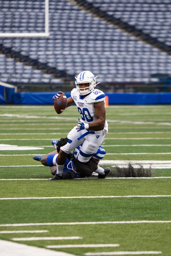 Matlin Marshall (80), white team wide receiver, gets tackled after catching a pass during the Georgia State University spring football game on Friday, April 16, 2021, at Center Parc Stadium in Atlanta. The white team defeated the blue team 23-17. CHRISTINA MATACOTTA FOR THE ATLANTA JOURNAL-CONSTITUTION