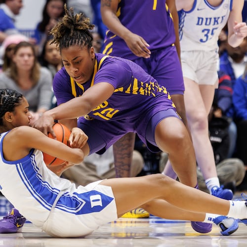 LSU's Mikaylah Williams (12) and Duke's Riley Nelson (4) battle for a loose ball during the second half of an NCAA college basketball game in Durham, N.C., Thursday, Dec. 4, 2025. (AP Photo/Ben McKeown)