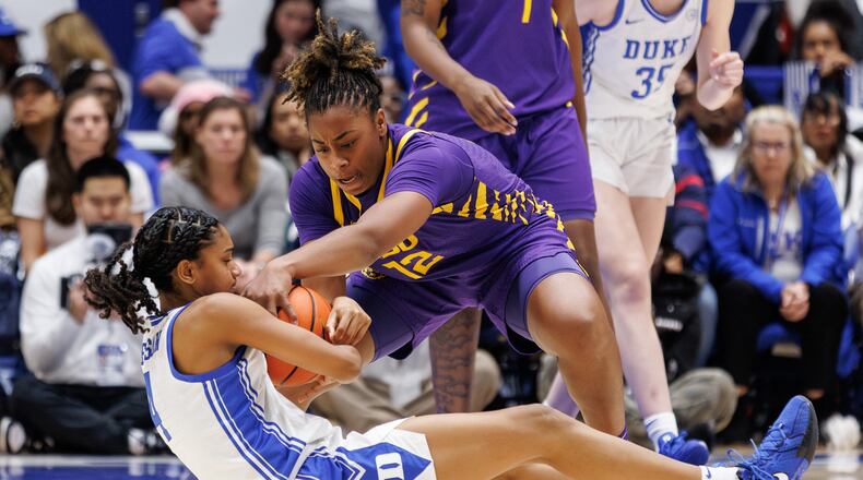 LSU's Mikaylah Williams (12) and Duke's Riley Nelson (4) battle for a loose ball during the second half of an NCAA college basketball game in Durham, N.C., Thursday, Dec. 4, 2025. (AP Photo/Ben McKeown)
