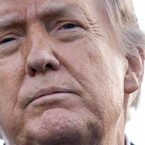 President Donald Trump listens to a reporter's question as he visits the Lincoln Memorial Reflecting Pool to see the new blue protective coating being applied as part of a renovation project, Thursday, May 7, 2026, in Washington. (AP Photo/Mark Schiefelbein)