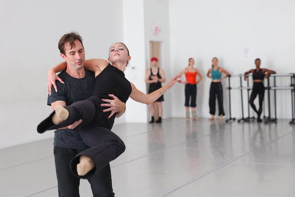 Christian Clark lifts Amalie Chase during rehearsal. (Arvin Temkar/AJC)