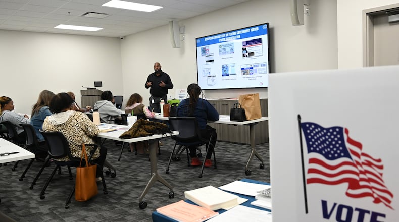 Poll workers participate earlier this month in training for early voting at the Fulton County Elections Hub and Operations Center in Fairburn. (Hyosub Shin / AJC)