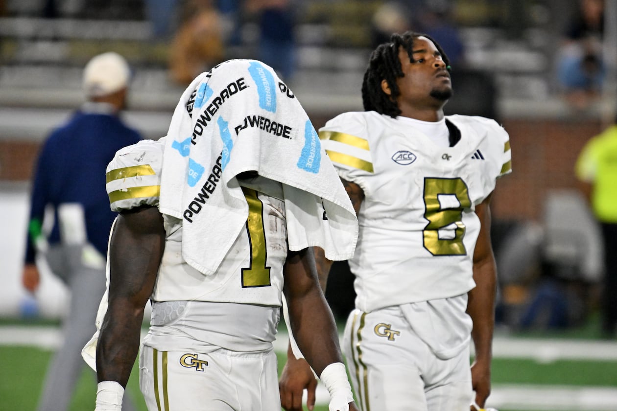 Georgia Tech running back Jamal Haynes (left) and wide receiver Malik Rutherford leave the field after Pittsburgh beat the Yellow Jackets on Saturday at Bobby Dodd Stadium. (Hyosub Shin/AJC)